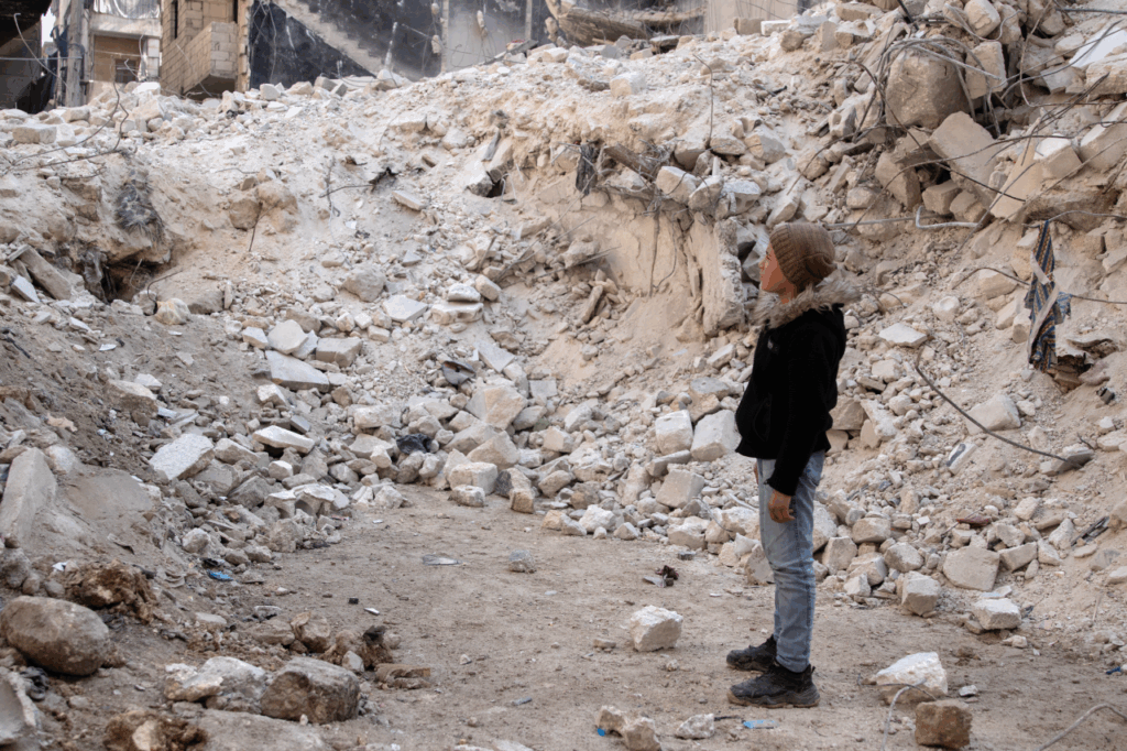 A boy gazes at the earthquake's rubble in Syria