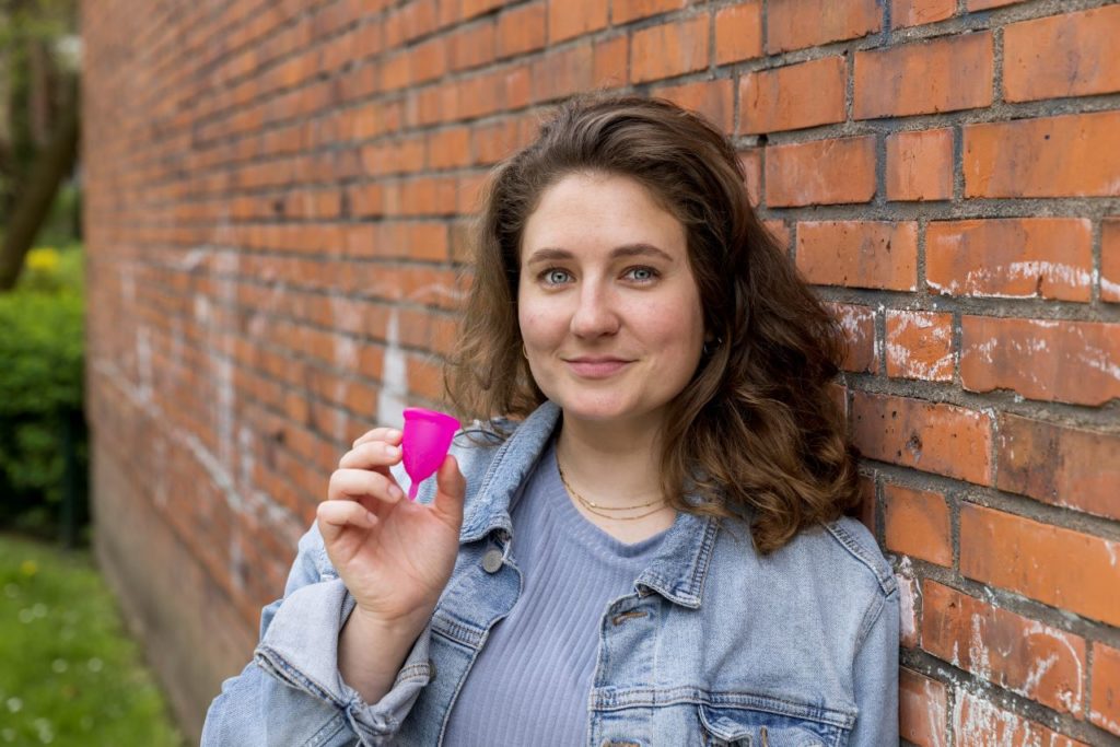 A women holds a menstrual cup