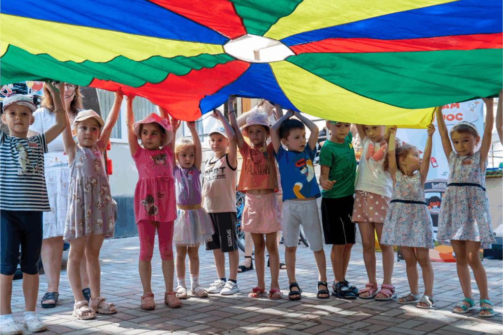 Children play with a parachute
