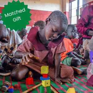 A child plays with blocks in a child-friendly space