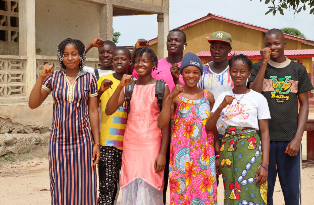 A group of young people stand together